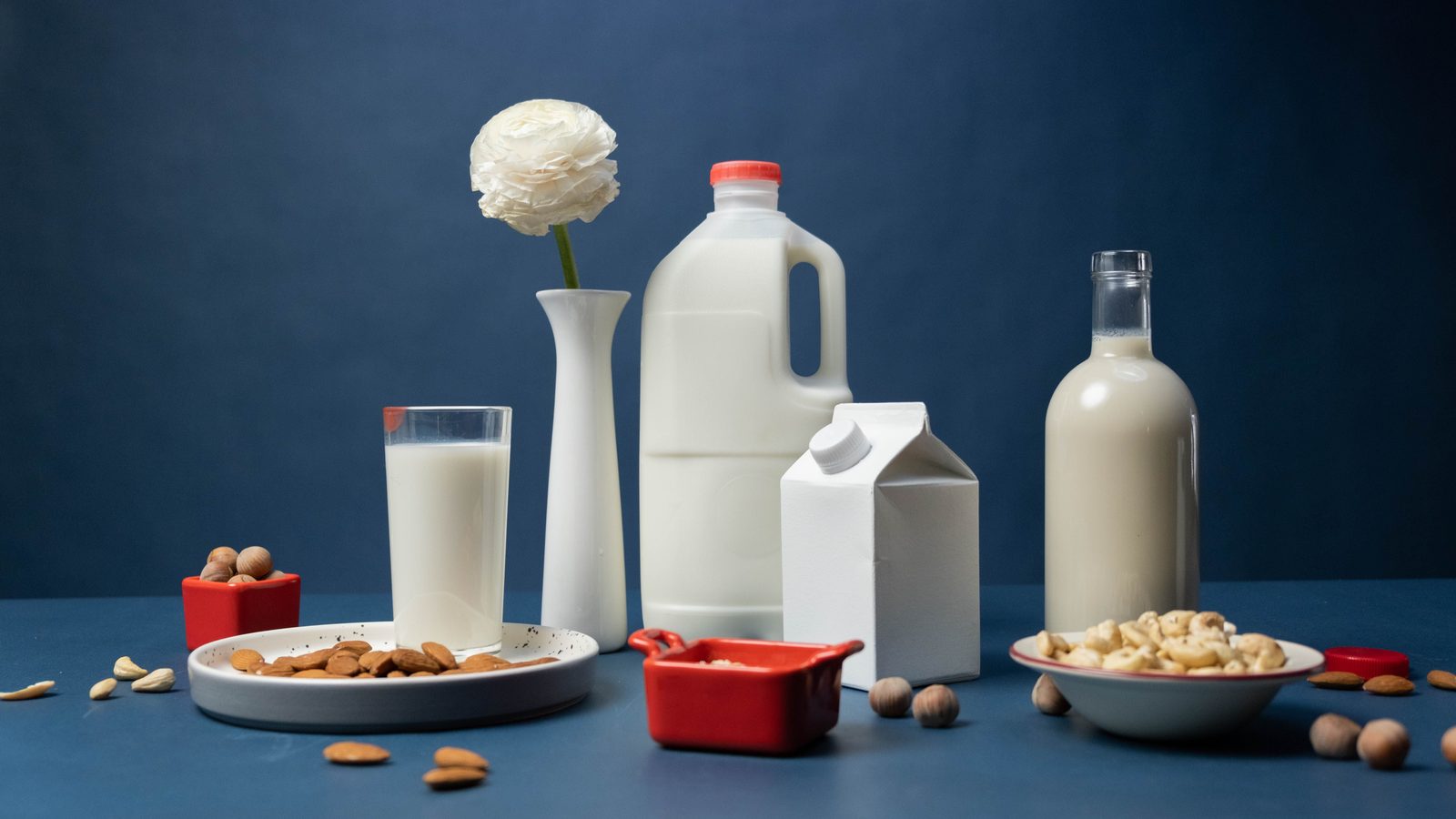 Glasses of almond, oat, soy and cashew milk side by side