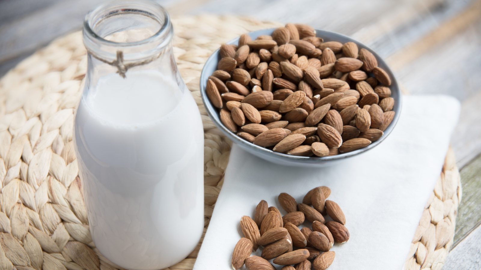 Pouring homemade plant milk in a home kitchen