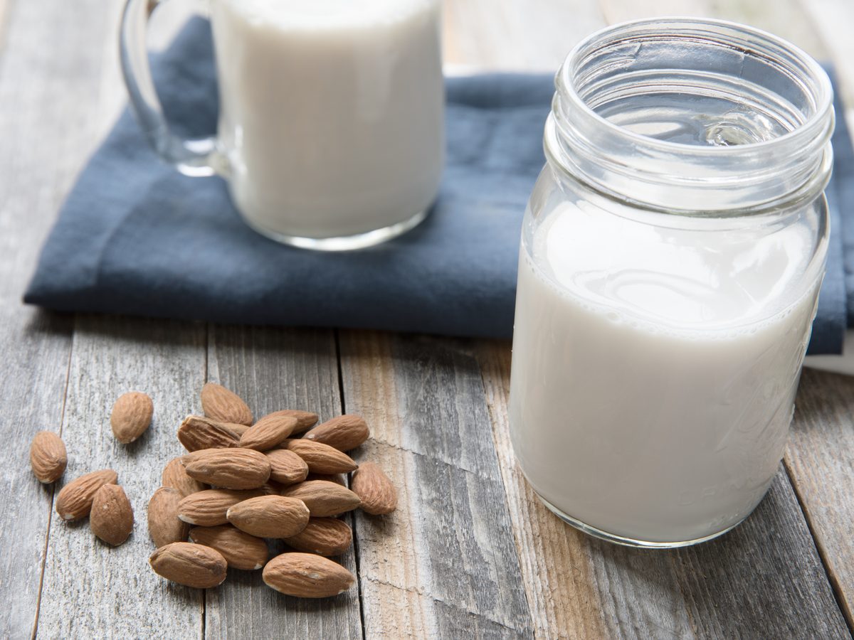 Almonds, oats and a bottle of homemade milk laid out on a counter